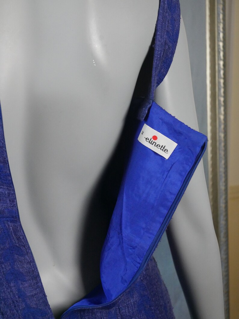 May include: A royal blue sleeveless dress with a zipper closure and a label that reads "elinette" on the inside.
