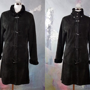May include: A black suede coat with a fur collar and toggle closures. The coat has a long, fitted silhouette and is lined with a soft, warm fabric.