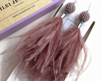 Orecchini con piume di struzzo color rosa antico: gioielli vistosi con perline