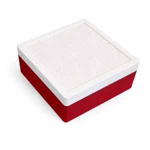 May include: A red and white square storage box. The box has a white, perforated top and a red base. The top is framed with a white border. The box is designed to hold small items.