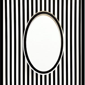 May include: An oval-shaped picture frame with a black and white striped background. The frame has a black border and a white interior. The background features vertical black and white stripes.