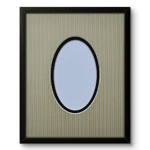 May include: Black framed picture frame with an oval aperture. The frame has a striped background in shades of green and tan. The oval opening has a black border and a light blue interior.