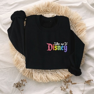 May include: Black sweatshirt with a rainbow coloured "Take me to Disney" graphic.