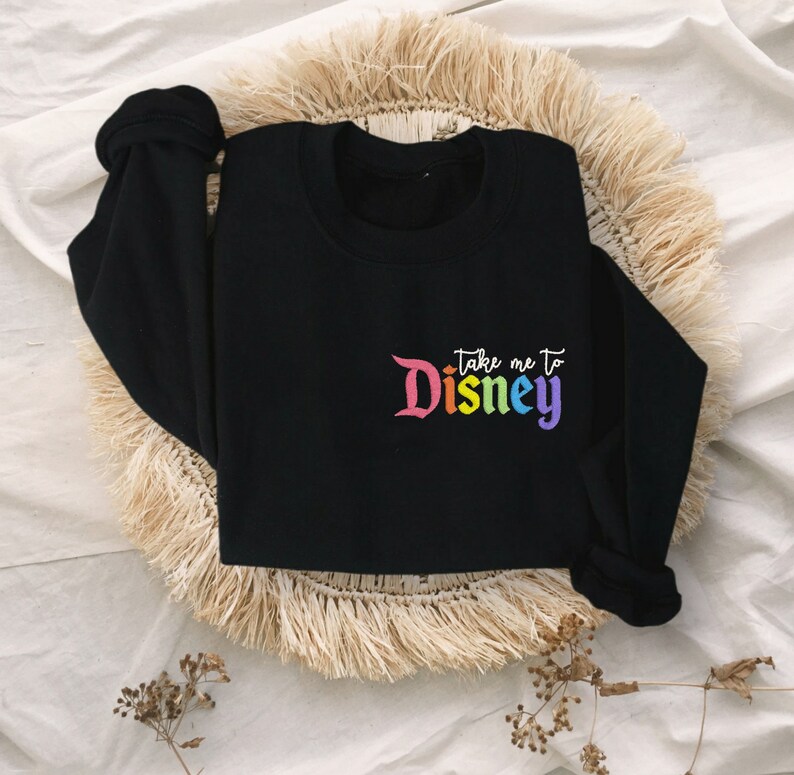 May include: Black sweatshirt with a rainbow coloured "Take me to Disney" graphic.