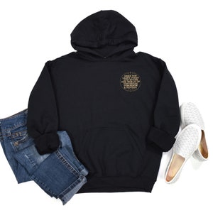 May include: Black hooded sweatshirt with a gold circle graphic that says "Here you leave today all that you have known of the world of yesterday & fantasy"
