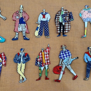 May include: Eleven fabric patches depicting stylized figures in various outfits, including a sailor suit and a plaid coat. One figure is on a skateboard. The patches are on a tan background.