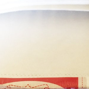 May include: Close-up of a red and white box with the text "kraft-tex" and "KRAFT PAPER FABRIC" printed on it.