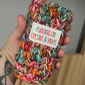 Crochet Skinny Can Cozy with “running on celcius & vibes” Patch