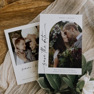May include: Save the date card with a white background and black text. The card features a photo of a couple kissing under an archway of greenery. The text reads "Simone + Branson" and "San Francisco | 07.26.xx formal invitation to follow".