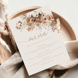 May include: A menu for a baby shower with a floral design. The menu includes starters, main course, dessert, coffee, and tea. The text on the menu reads "Aiden's Baby Shower | 08.27.xx".