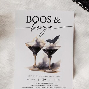 May include: A Halloween party invitation with a black and white illustration of two martini glasses with smoke and a bat. The text reads "BOOS & booze" and includes the date, time, and location of the party.
