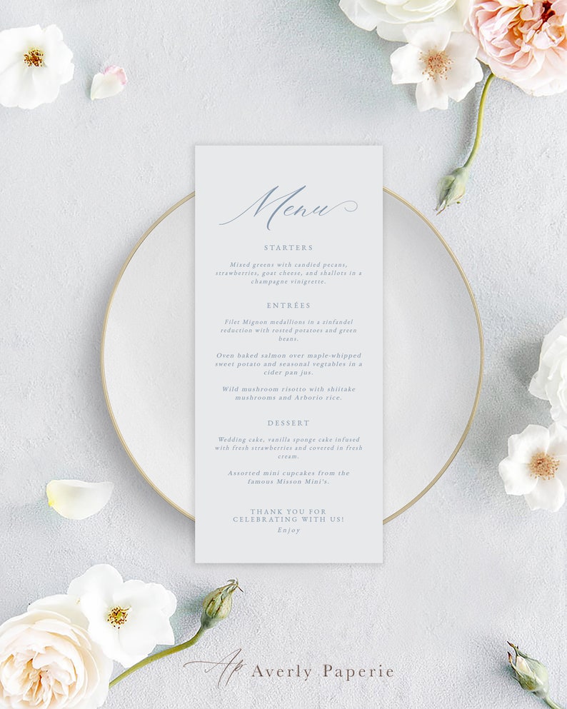 May include: A light blue menu card with a handwritten 'Menu' title. The menu lists starters, entrees, and desserts. The text includes 'Mixed greens with candied pecans, strawberries, goat cheese, and shallots in champagne vinaigrette.' and 'Filet Mignon medallions in a sinfandel reduction with roasted potatoes and green beans.'