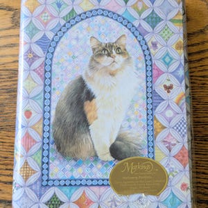 May include: A set of three ceramic mugs with a speckled, matte finish. The mugs are in shades of cream, light gray, and dark gray. Each mug has a simple, minimalist design and a rounded handle.