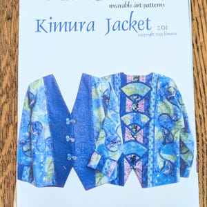 May include: A pattern for a Kimura Jacket, featuring a blue and white design. The cover displays the jacket's design, with the text "KIMURA" and "Kimura Jacket 2.01" in blue. Copyright 1995 Kimura is also visible.
