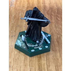 May include: A set of three ceramic mugs with a speckled, matte finish. The mugs are in shades of cream, light gray, and dark gray. Each mug has a simple, minimalist design and a rounded handle.