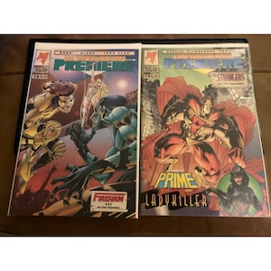 May include: Two comic books from the Malibu Comics series Premiere. The comic books feature colorful illustrations of superheroes and villains in action poses. One comic book has the text "Firearm" and the other has the text "Prime" and "Ladykiller".