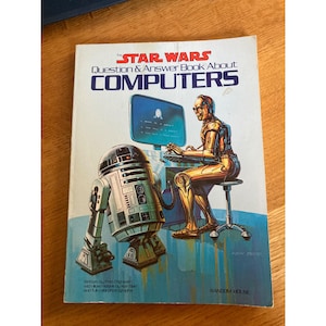May include: A vintage Star Wars book titled "Question & Answer Book About Computers." The cover features illustrations of R2-D2, C-3PO, and a computer screen. The book is published by Random House.