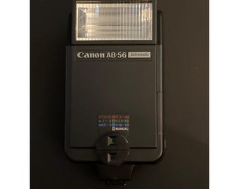 Flash automático Canon AB-56 con estuche y manual