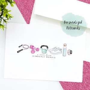 May include: A white card with a note from Kimberly Morris. The card features a line of fitness-themed illustrations, including a jump rope, dumbbells, a kettlebell, running shoes, a water bottle, and a fitness tracker.