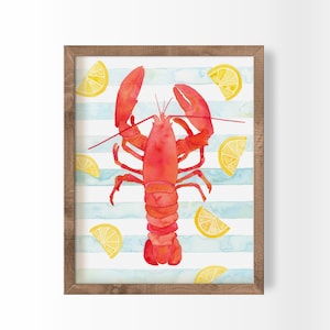 May include: Watercolor print of a red lobster and yellow lemon slices on a background of blue and white stripes. The artwork is framed in a natural wood frame, perfect for coastal or nautical decor.