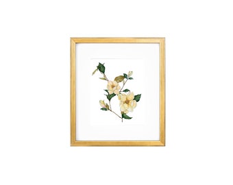 May include: A framed watercolor painting of a yellow camellia flower branch with green leaves.