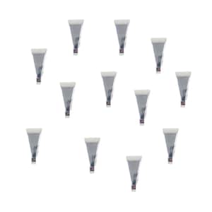 May include: A collection of twelve silver-colored, triangular-shaped metal clips with white tops and small brown accents. The clips are arranged against a white background, creating a pattern.