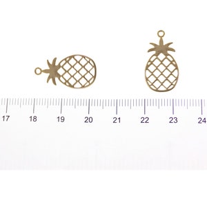 Gold pineapple charm 22.8 mm shown with size reference for scale
