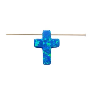 Close‑up of blue opal cross charm with side hole for DIY jewelry