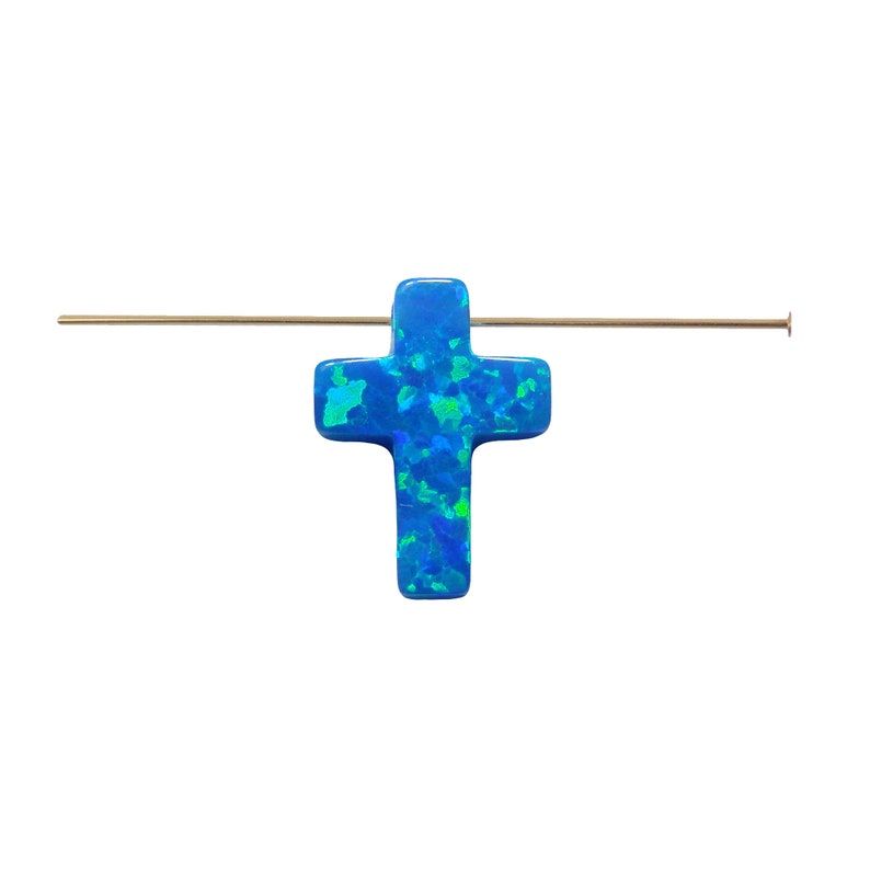 Close‑up of blue opal cross charm with side hole for DIY jewelry