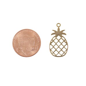 Gold pineapple charm 22.8 mm shown with size reference for scale