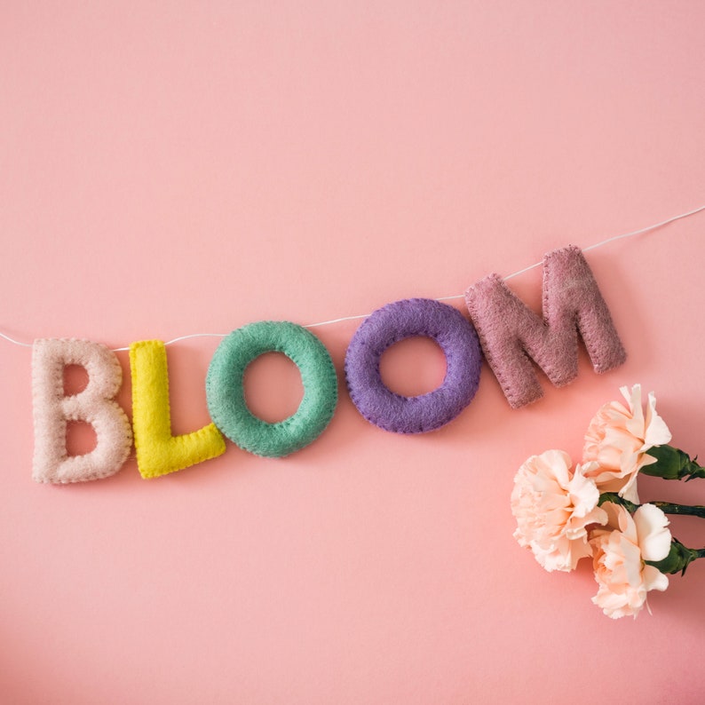 Wool felt letter garlands are an easy way to add a little color and whimsy to your birthday party, play room, or any other room in your home. Party, celebration, home decor, nursery, spring