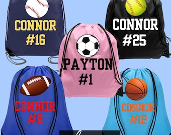 May include: Five drawstring bags in navy, black, pink, blue, and light blue. Each bag features a sports ball graphic, a name, and a number. The bags display the names Connor and Payton, with numbers 16, 25, 1, 8, and 12 printed in bold fonts.