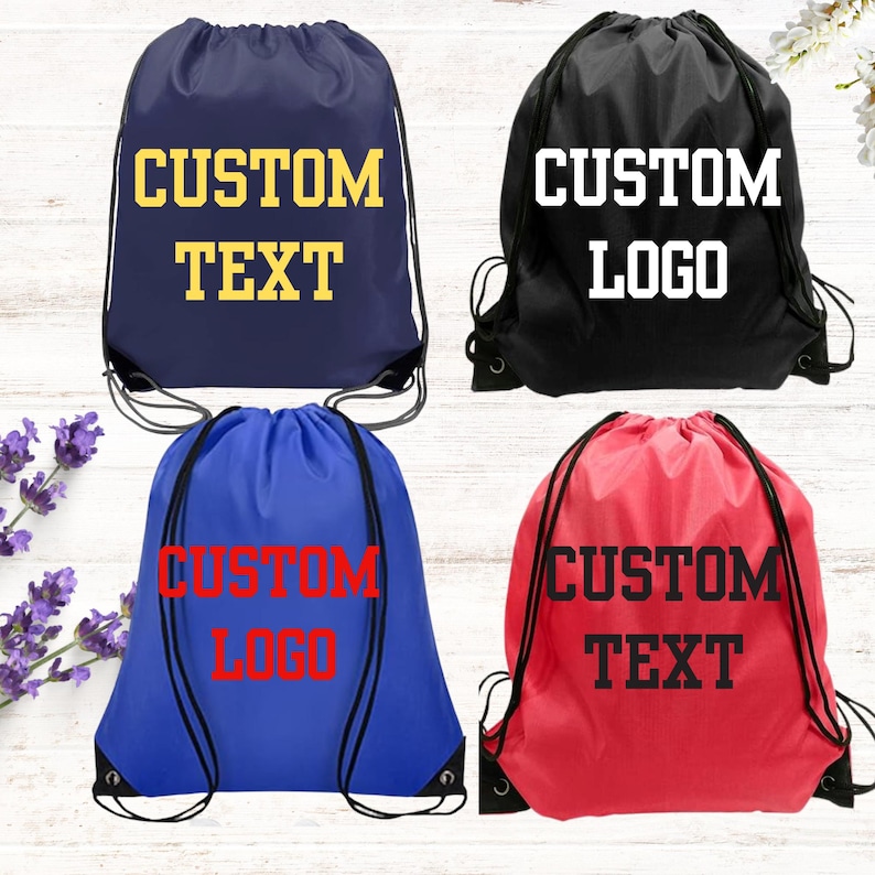 May include: Four drawstring bags in navy blue, black, royal blue, and red. The navy bag features yellow text reading CUSTOM TEXT. The black bag has white text reading CUSTOM LOGO. The royal blue bag has red text reading CUSTOM LOGO. The red bag has black text reading CUSTOM TEXT.