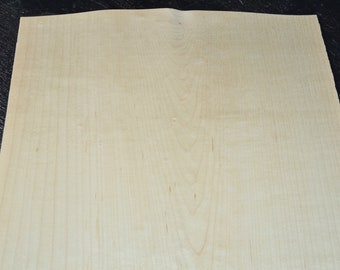 May include: A sheet of light brown wood veneer with a smooth surface and a subtle grain pattern.