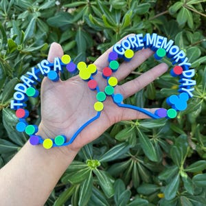 May include: A set of three ceramic mugs with a speckled, matte finish. The mugs are in shades of cream, light gray, and dark gray. Each mug has a simple, minimalist design and a rounded handle.