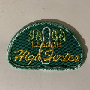 May include: Green and gold embroidered patch with a bowling pin and the text "YABA LEAGUE High Series".