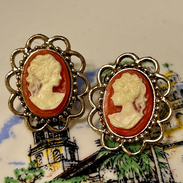 Cameo earrings with scalloped design gold tone new old stock 1980s Victorian style 3/4in length 3/4in. Width.