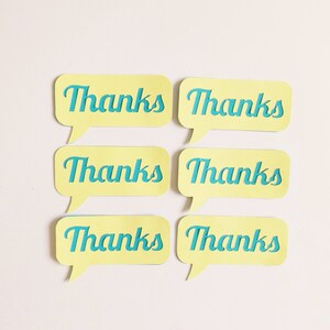 May include: Six yellow speech bubbles with rounded corners and blue text that reads "Thanks" on each bubble.