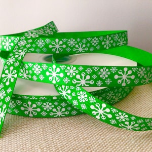 5/8” White Glitter Snowflakes on Green Grosgrain Ribbon