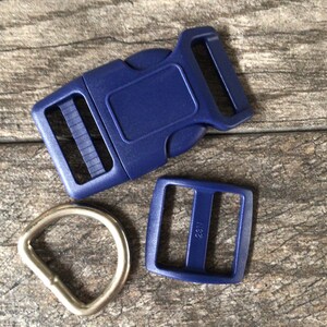 May include: A set of blue plastic hardware for making dog collars or leashes. The set includes a side release buckle, a slider buckle, and a D-ring.