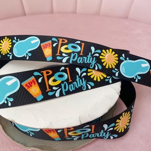 May include: Black ribbon featuring a repeating pattern of a pool, sun, sunscreen, and the words "Pool Party" in a playful font. The ribbon is ideal for crafting and party decorations.
