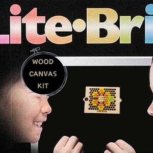 May include: A Lite-Brite toy box with the words "Lite-Brite" in colorful letters. The box features two children looking at a wooden canvas kit with colorful pegs. The kit is for ages 4 to adult.