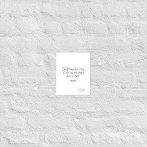 May include: A white print with the quote "Don't worry about a thing cause every little thing is gonna be alright" in elegant script. The print includes a small feather illustration and a signature at the bottom.