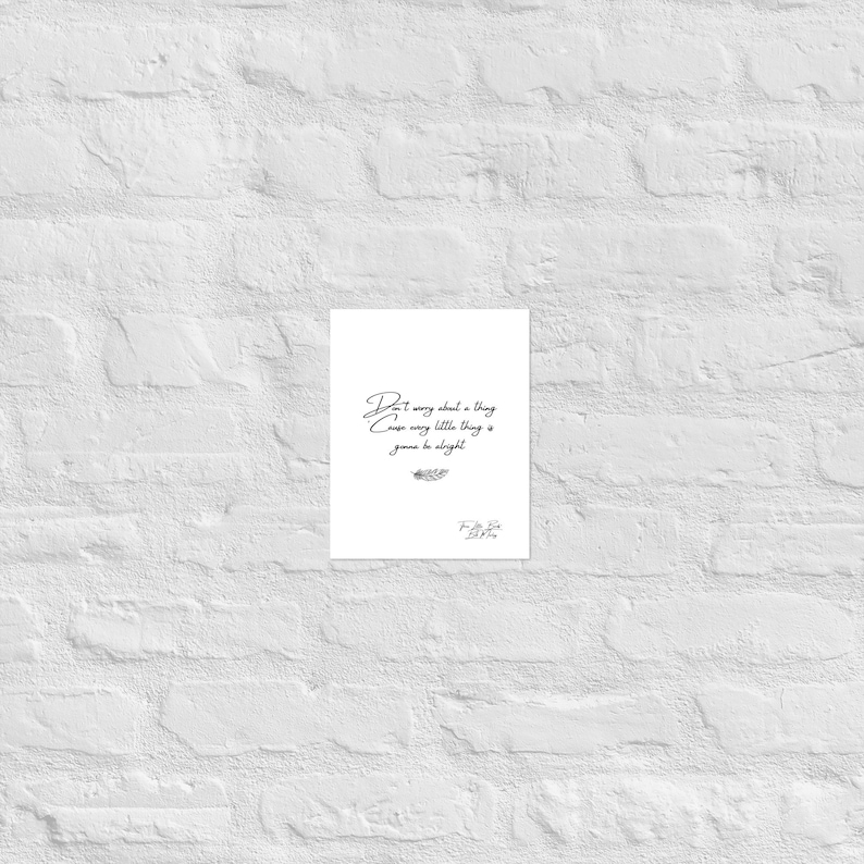 May include: A white print with the quote "Don't worry about a thing cause every little thing is gonna be alright" in elegant script. The print includes a small feather illustration and a signature at the bottom.
