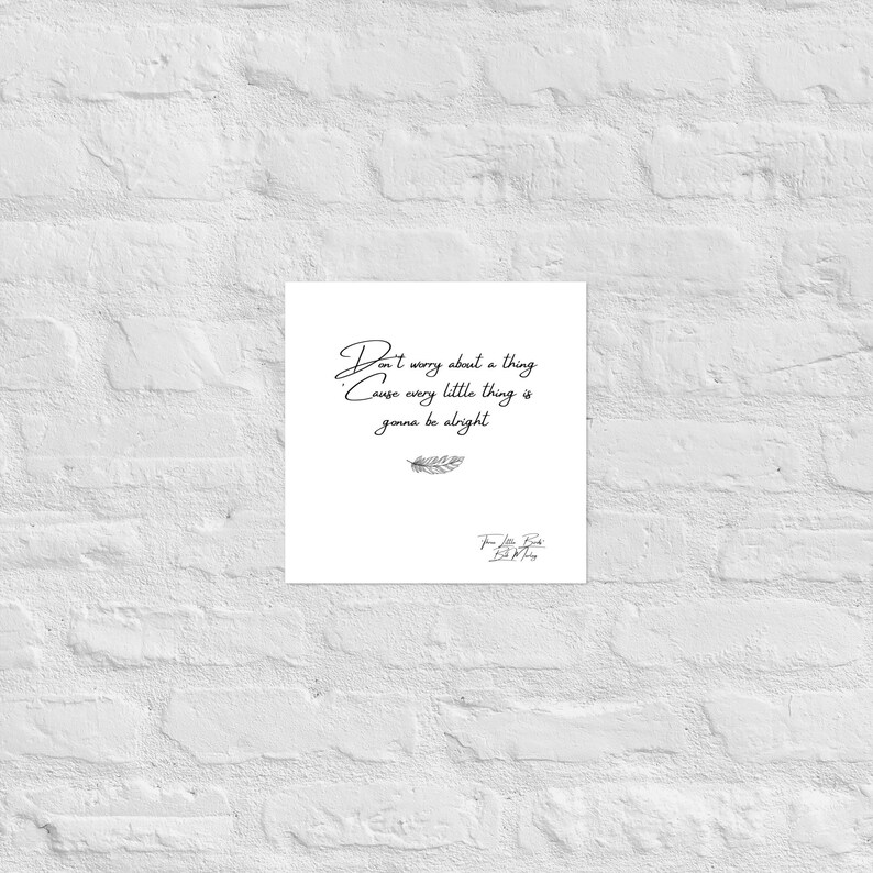 May include: A white square print with the handwritten text "Don't worry about a thing Cause every little thing is gonna be alright." A small feather illustration is below the text, and a signature is at the bottom.