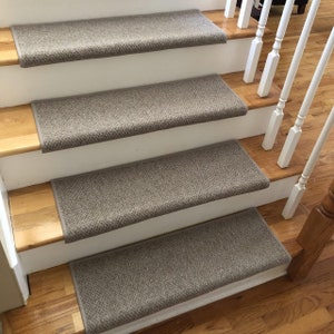 May include: A set of four brown stair treads with a textured surface. The treads are made of a soft, durable material and are designed to help prevent slips and falls.