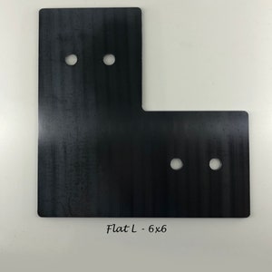 May include: Black metal L-shaped bracket with four holes. The bracket is labeled "Flat L - 6x6".
