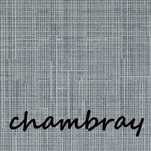 May include: Close-up of a textured chambray fabric in shades of blue and white. The word "chambray" is written in a cursive font across the bottom of the image. The fabric has a woven appearance.