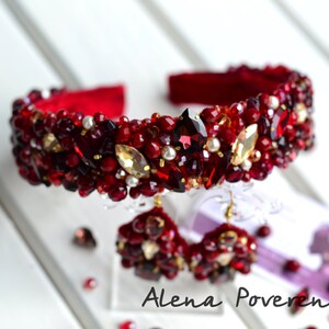 May include: A red headband and matching earrings with red and gold beads and rhinestones.