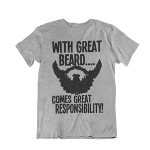 May include: A heather gray t-shirt with the text "WITH GREAT BEARD....COMES GREAT RESPONSIBILITY!" in black. A black beard graphic is centered below the text. The shirt is a short-sleeved crew neck.